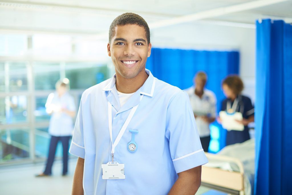A male healthcare professional working in a clinical setting