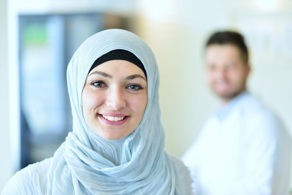 A healthcare professional wearing a headscarf in a hospital setting